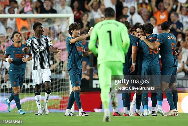 Filip Ugrinic of Valencia celebrates scoring his team's first goal with teammates during the during the pre-season friendly match between Valencia CF...