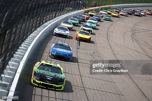 Ryan Blaney, driver of the Menards/Pennington Ford, leads the field during the NASCAR Cup Series Iowa Corn 350 Powered by Ethanol at Iowa Speedway on...