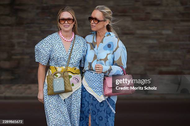 Olivia Minns and Alice Minns are seen wearing full looks by Marimekko; Olivia wearing a blue printed puff sleeve top with matching wide leg trousers;...