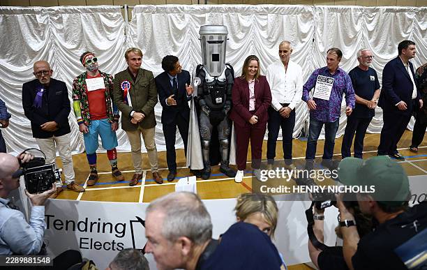 Candidates, including Count Binface , listen to the results for the by-election result for the parliamentary seat of Clacton, at the count centre...
