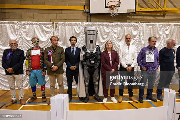 Candidates including Count Binface, a Count Binface Party candidate, center, await the results for the Clacton parliamentary constituency by-election...