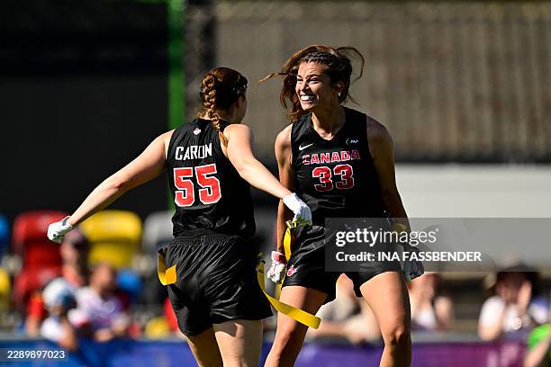 Japan's Laurence Marie Jeanne Caron and Canada's Catherine Gaumont celebrate during the women's match between Japan and Canada at the "IFAF World...