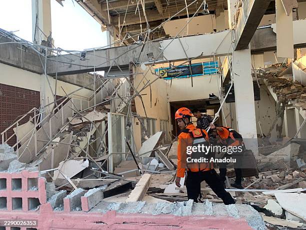 Indonesian military and rescue personnel search through debris at a damaged building following a magnitude 7.7 earthquake that struck offshore near...