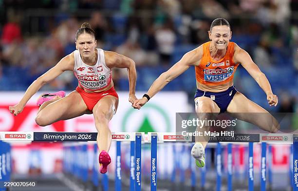 Nadine Visser of Team Netherlands and Pia Skrzyszowska of Team Poland clear the last hurdle in the Women's 100 Metres Hurdles Final during day two of...