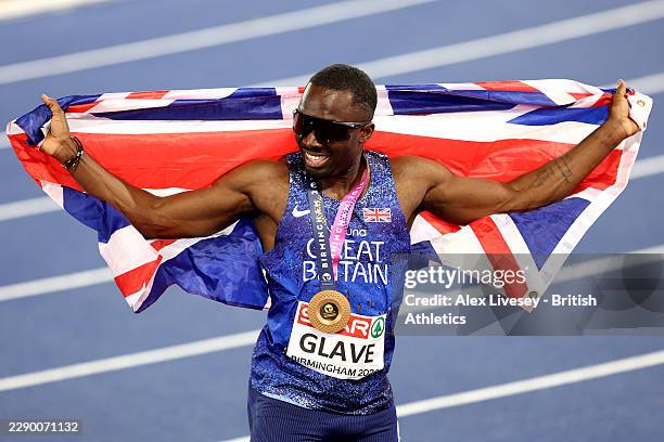 Gold medallist, Romell Glave of Team Great Britain, celebrates with the national flag after victory in the Men's 100m Final during day two of the...