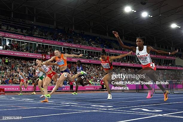 Pia Skrzyszowska of Team Poland and Nadine Visser of Team Netherlands stretch to cross the finish line in the Women's 100m Hurdles Final during day...