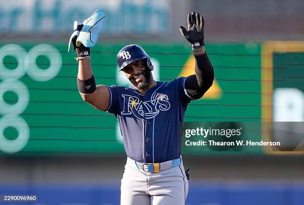 Yandy Díaz of the Tampa Bay Rays standing on second base reacts after reaching on a two base error committed by Henry Bolte of the Athletics in the...