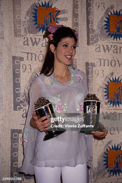 American actress Marisa Tomei during the 2nd Annual MTV Movie Awards at Disney Studios in Burbank, California, 5th June 1993. Tomei is seen holding...