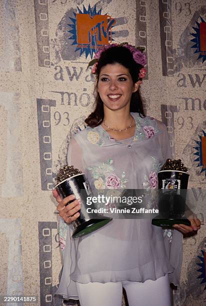 American actress Marisa Tomei during the 2nd Annual MTV Movie Awards at Disney Studios in Burbank, California, 5th June 1993. Tomei is seen holding...