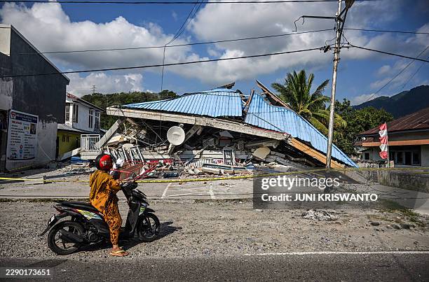Motorbike stops next to a collapsed building following a 7.7-magnitude earthquake in Borong, East Manggarai, East Nusa Tenggara on August 16, 2026....