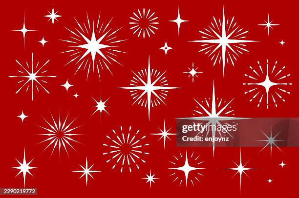 white christmas sparkling star symbols on red background - tree topper stock illustrations