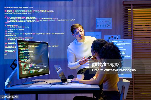 software engineers collaborating on artificial intelligence development, discussing complex coding algorithms for advanced machine learning solutions, projecting digital data - devops stock pictures, royalty-free photos & images
