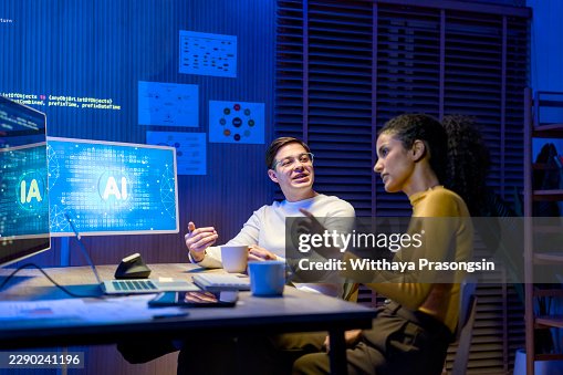 Diverse programmers collaborating on artificial intelligence development in a modern tech office, brainstorming data science concepts for machine learning applications at night Diverse programmers collaborating on artificial intelligence development in a modern tech office, brainstorming data science concepts for machine learning applications at night