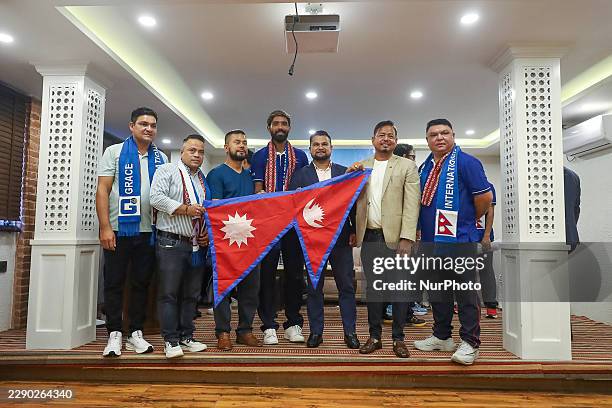 Officials from the Cricket Association of Nepal hand over the national flag of Nepal as they bid farewell to the Nepal 'A' cricket team for the 'Top...