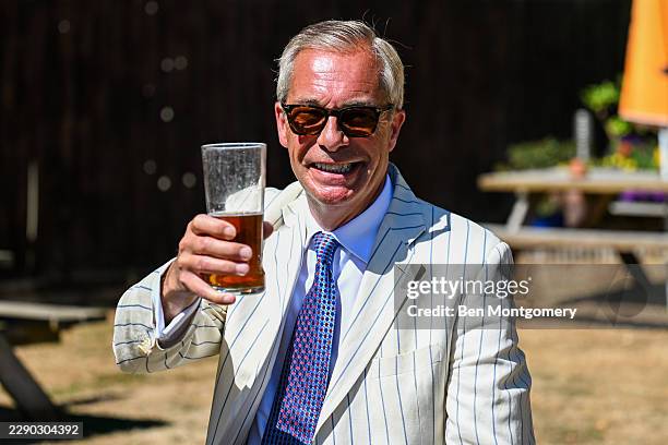 Nigel Farage is seen drinking a pint at The Ship pub in Clacton on August 13, 2026 in Clacton-on-Sea, England. The Clacton-on-Sea by-election was...