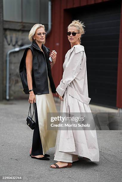 Zuzana N. Straska is seen wearing a black textured sleeveless oversized vest; a cream satin maxi dress; narrow sunglasses; with her blonde hair worn...