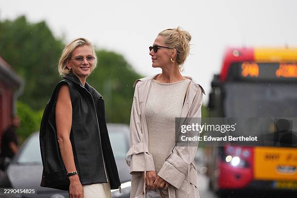 Guest wears a sleeveless black leather jacket ; a guest wears blonde hair in a tousled bun, earrings, black rectangular sunglasses with dark lenses,...