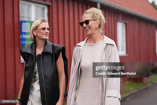Guest wears a sleeveless black leather jacket, a satin dress ; a guest wears blonde hair in a tousled bun, earrings, black rectangular sunglasses...