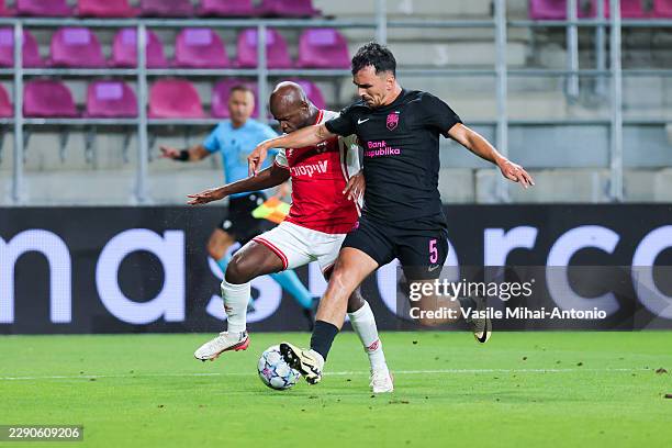 Javon East of Hapoel Beer-Sheva runs to the ball with Rahman Dashdamirov of Sabah during the UEFA Champions League 2026/27 play-offs first leg match...