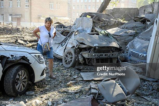 Local residents inspect cars burned in a Russian overnight missile and drone attack in Kyiv, Ukraine, on August 20, 2026. Russia attacked Kyiv and...