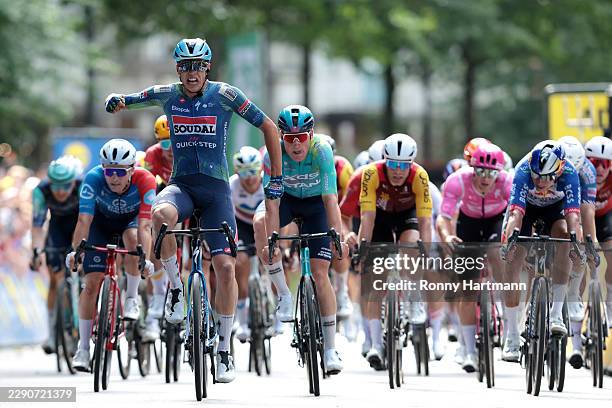 Paul Magnier of France and Team Soudal Quick-Step celebrates at finish line as race winner ahead of Mike Teunissen of Netherlands and Team XDS Astana...