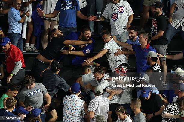 Chicago Cubs and Chicago White Sox fans fight in the bleachers during the eighth inning at Wrigley Field on August 17, 2026 in Chicago, Illinois.