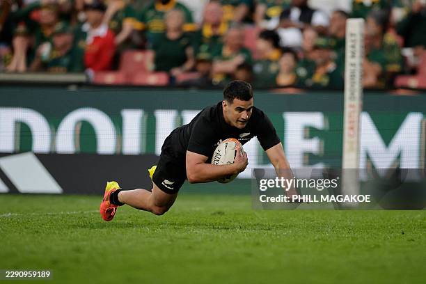 New Zealand's wing Josh Moorby dives to score a try during the Rugby's Greatest Rivalry international rugby union match between South Africa and New...