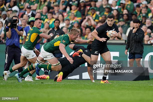 New Zealand's wing Josh Moorby runs to score a try during the Rugby's Greatest Rivalry international rugby union match between South Africa and New...