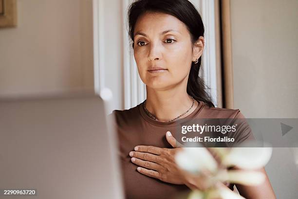 woman practicing mindfulness during remote work at laptop in a calm home office setting - initiative stock pictures, royalty-free photos & images