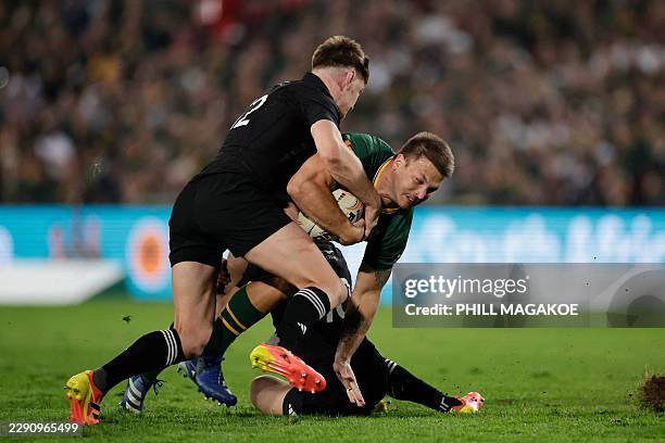 New Zealand's centre Jordie Barrett takcles South Africa's centre Andre Esterhuizen during the Rugby's Greatest Rivalry international rugby union...