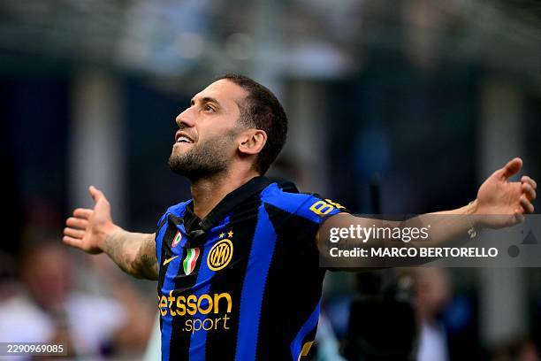Inter Milan's Turkish midfielder Hakan Calhanoglu celebrates after scoring his team first goal during the Italian Serie A football match between...