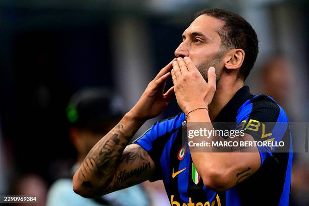 Inter Milan's Turkish midfielder Hakan Calhanoglu celebrates after scoring his team first goal during the Italian Serie A football match between...