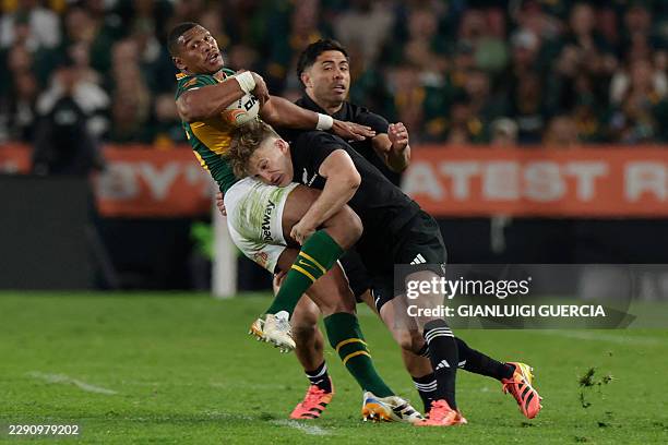 South Africa's fullback Damian Willemse is tackled during the Rugby's Greatest Rivalry international rugby union match between South Africa and New...