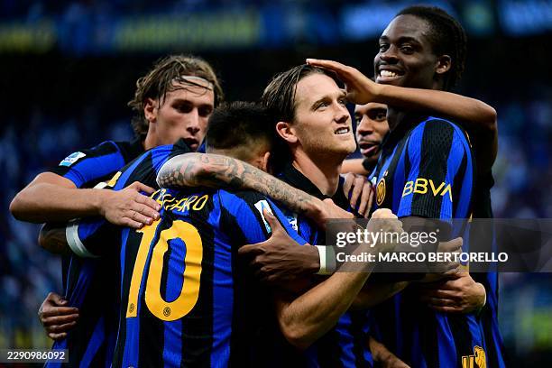 Inter Milan's Polish midfielder Piotr Zielinski celebrates with teammates after scoring his team second goal during the Italian Serie A football...