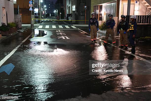 Street is partially flooded in Tokyo in the early hours of Aug. 23 following the rupture of a water pipe triggered by a strong earthquake that struck...