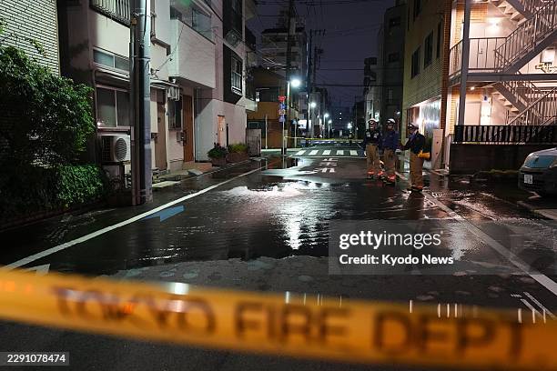 Street is partially flooded in Tokyo in the early hours of Aug. 23 following the rupture of a water pipe triggered by a strong earthquake that struck...