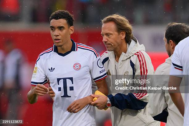 Jamal Musiala of FC Bayern München leaves the pitch after he broke down on the pitch during the preseason friendly match between 1. FC Heidenheim and...