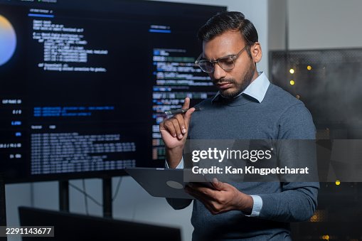 Software Engineer Reviewing Artificial Intelligence Code Suggestions and Monitoring Technical System Data. Software Engineer Reviewing Artificial Intelligence Code Suggestions and Monitoring Technical System Data.