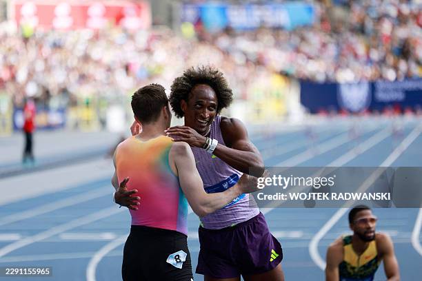 Winner Brazil's Alison dos Santos celebrates with second placed Norway's Karsten Warholm after winning the men's 400 m hurdles competition of the...
