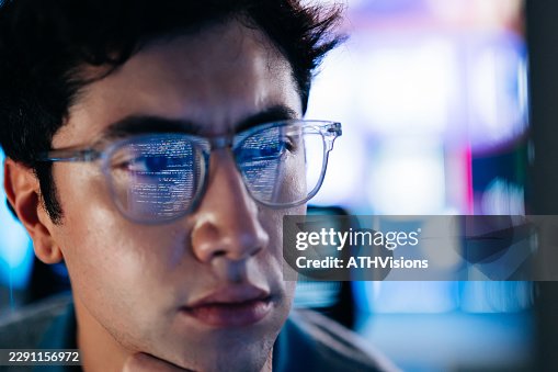 Young software developer studying code on computer screen Young software developer studying code on computer screen