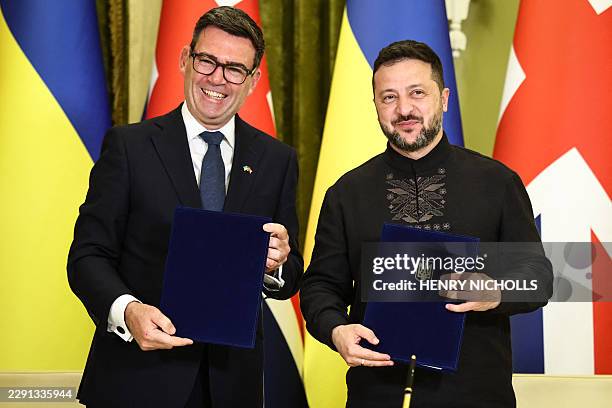 Ukraine's President Volodymyr Zelensky and Britain's Prime Minister Andy Burnham pose after signing a partnership deal on AI following a bilateral...
