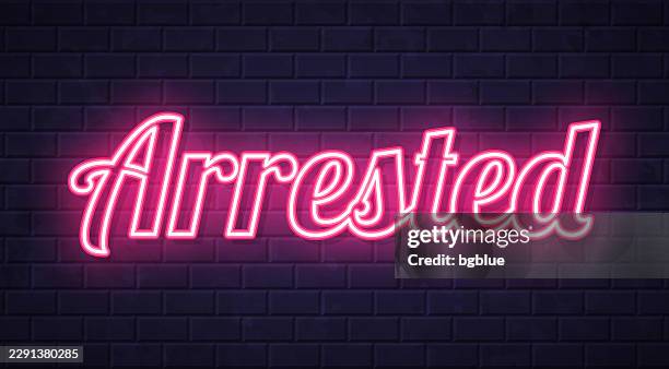 arrested - glowing neon text on brick wall background - catch words stock illustrations