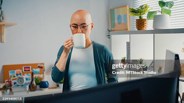 young asian female software engineer cancer patient drinking coffee while examining complex binary code on monitor at the home. machine learning, network security, artificial intelligence concept. - javascript stock pictures, royalty-free photos & images