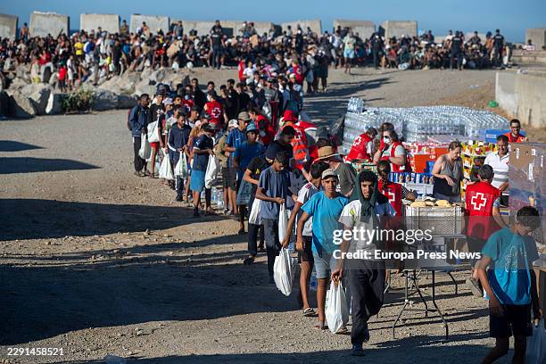 Red Cross members are distributing food to migrants on a beach on 21 August 2026 in Ceuta, Spain. Ceuta continues to face a serious humanitarian...