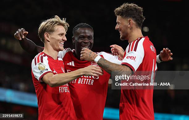 Martin Odegaard of Arsenal celebrates after scoring a goal to make it 3-0 with Bukayo Saka and Ben White during the Premier League 2026/27 match...