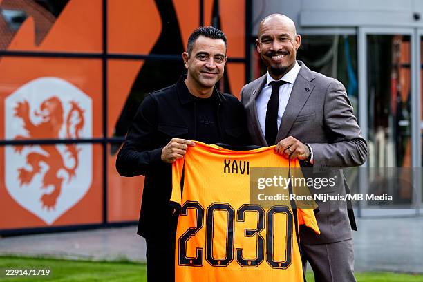 Netherlands head coach Xavi Hernandez and KNVB director of football Nigel de Jong pose with a Netherlands jersey during the unveiling of Xavi...