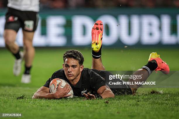 New Zealand's scrum-half Noah Hotham scores a try during the rugby union tour match between New Zealand and The Lions at Ellis Park Stadium in...