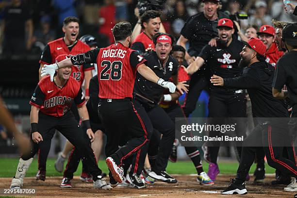 Jake Rogers of the Chicago White Sox is greeted at home after hitting a two run walk-off home run against the New York Mets during the ninth inning...