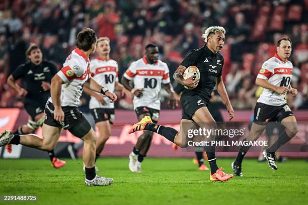 New Zealand's centre Rieko Ioane runs with the ball to score a try during the rugby union tour match between New Zealand and The Lions at Ellis Park...
