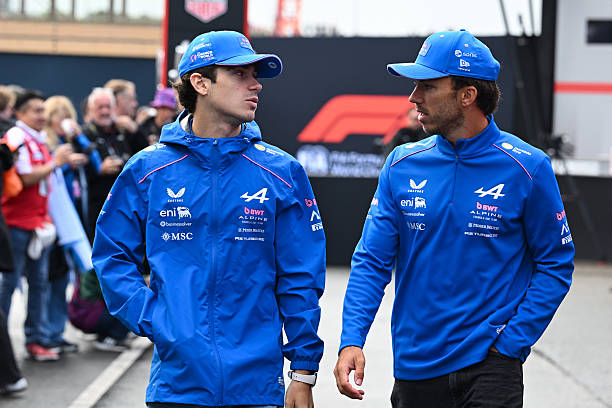 Franco Colapinto of Argentina and Alpine F1 and Pierre Gasly of France and Alpine F1 talk as they walk in the Paddock prior to the Sprint ahead of...